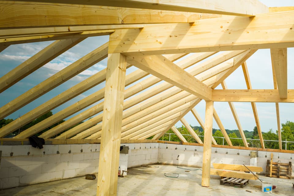 New timber roof framing against the sky